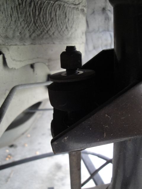 2003 Ford Taurus - A detailed view of a vehicle's suspension system, focusing on a rubber bushing and bolt assembly.