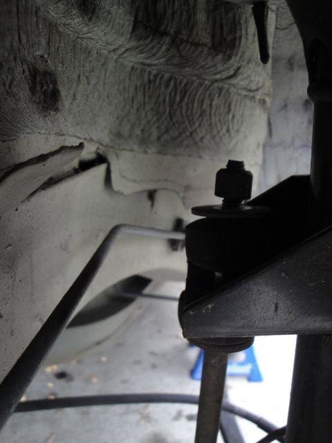 2003 Ford Taurus - A detailed view of a vehicle's suspension system, focusing on a specific mechanical part.