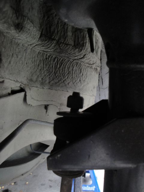 2003 Ford Taurus - Detail of a vehicle's suspension system, focusing on a linkage joint.