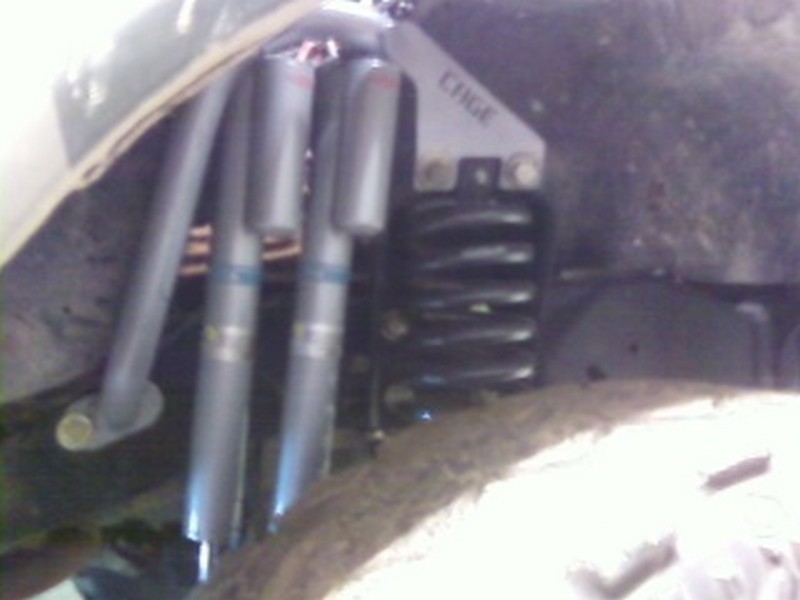 Suspension components with 'CHGE' label and coilover shocks