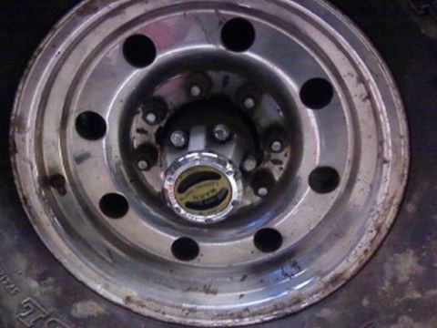 1995 Ford Bronco - A close-up view of a vehicle's wheel hub, a prominent 'WARN LOCKING HUBS' cap.