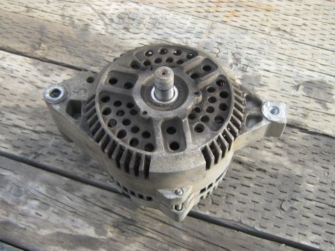 1972 Ford F-250 - This is a close-up view of a vehicle alternator, a component that generates electrical power.