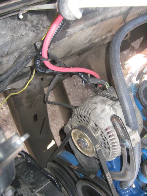 1972 Ford F-250 - Close-up view of an alternator and associated wiring within an engine compartment.