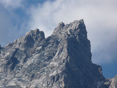 2006 Ford E350 - A close-up view of a mountain peak under a partly cloudy sky.