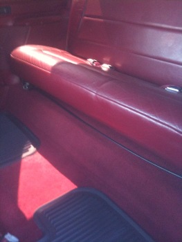 1995 Ford Bronco - Interior view of red seats and carpeting with a SuperMotors watermark at the bottom.