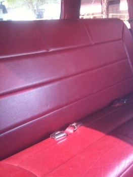 1995 Ford Bronco - Interior view of red seats and seatbelts, with a Supermotors.net watermark.