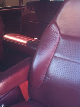 1995 Ford Bronco - Interior view of a vehicle's red leather seats and door panels, with a watermark at the bottom.