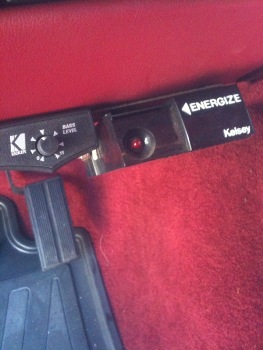 1995 Ford Bronco - Close-up of an aftermarket Kicker amplifier control knob and an Energize indicator light inside a vehicle.