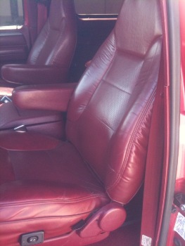 1995 Ford Bronco - Interior view of red leather seats with armrests.