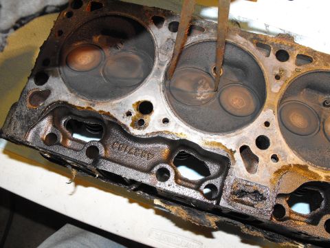 1982 Chrysler New Yorker - Off with the old open chambered 82' New Yorker 318 4bbl heads part # 4027163. Plain 1.78 intake valves and chambers so large you barely ach…