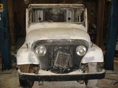1974 Jeep CJ5 - Front view of a 1974 Jeep CJ5 body undergoing restoration, showing primer and bare metal.