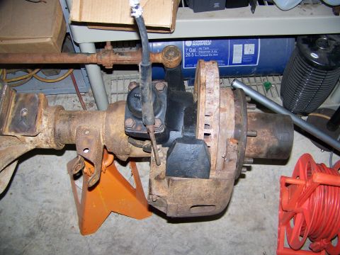 1992 Jeep YJ - Front axle assembly, likely from a Jeep, is shown with brake components and suspension linkage.