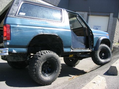 1986 Ford Bronco - This lifted 1986 Ford Bronco features off-road tires and a distinctive blue paint job.