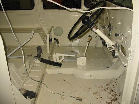 1974 Jeep CJ5 - The interior of a vehicle is shown, appearing to be in a state of restoration with exposed floor and dashboard components.