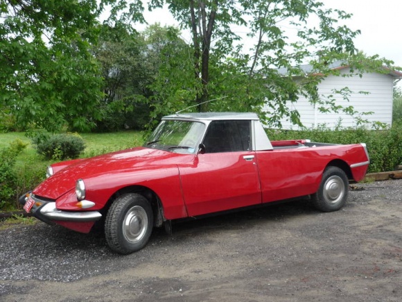 Red Citroen DS converted into a pickup parked on gravel