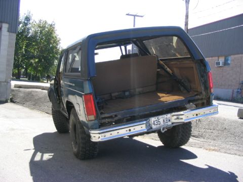 1986 Ford Bronco - This Ford Bronco appears to be from the early 1980s, not 1986, with a damaged rear bumper.
