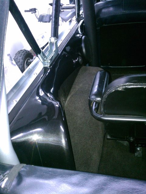 1975 Ford Bronco - Interior view of a vehicle, possibly a Bronco, with a roll cage and seats visible.