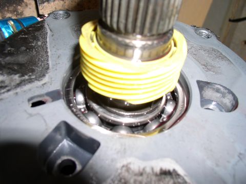 1988 Ford Bronco - Detail of a transfer case part, showing ball bearings and a yellow seal during a rebuild.