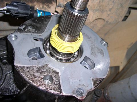 1988 Ford Bronco - Close-up view of a transfer case component, showing a bearing and a splined shaft during a rebuild.