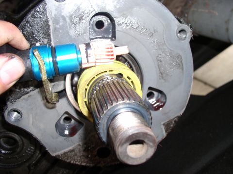 1988 Ford Bronco - A close-up view of a vehicle's transfer case input shaft and associated sensor during a rebuild.