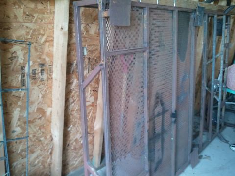 1995 Ford Bronco - Metal storage rack with mesh panels, seen indoors against a wall.
