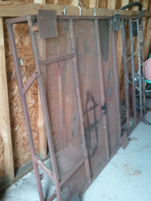 1995 Ford Bronco - Several sections of a metal rack, possibly for storage or transport, are shown leaning against a wooden wall.