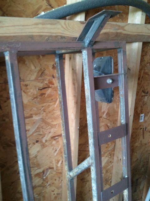 1995 Ford Bronco - Metal rack structure with visible brackets and bolts, stored indoors.