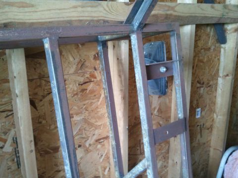 1995 Ford Bronco - A close-up view of a metal rack assembly, showing its construction and mounting against a wall.