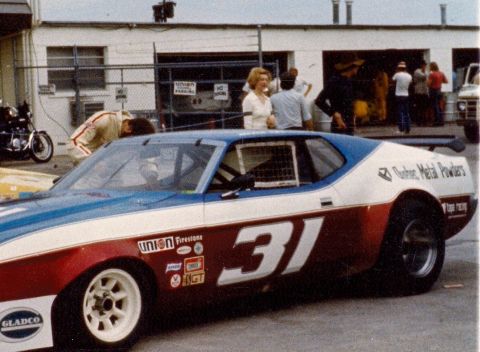 1973 Ford Mustang - A race car with the number 31 prominently displayed on its side, a red, white, and blue paint scheme.