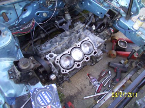 1995 Ford Probe - Engine block and associated parts are laid out on the ground, suggesting a repair or rebuild in progress.