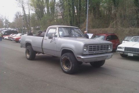 1991 Ford LTD Crown Victoria - A silver pickup truck from the 1970s is parked at an outdoor event with other vehicles visible.