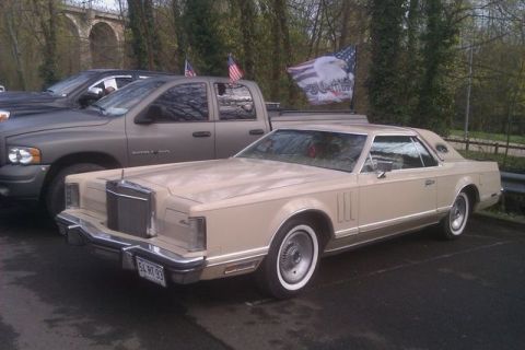 1991 Ford LTD Crown Victoria - This 1977 Lincoln Continental Mark V coupe is seen parked next to a pickup truck, American flags and an eagle graphic on the truck's bed.
