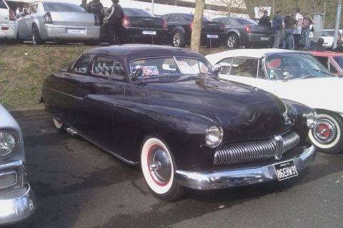1991 Ford LTD Crown Victoria - A 1950 Mercury Eight Coupe is parked next to a white convertible.