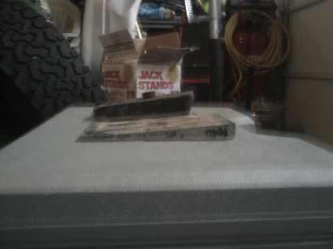 1994 Ford Bronco - Jack stands and a tire are visible in a cluttered garage environment.