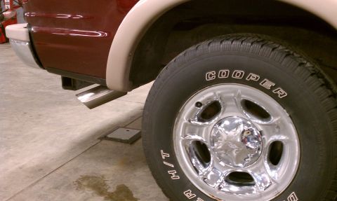 1999 Ford Expedition - Close-up of the rear wheel and chrome exhaust on a 1999 Ford Expedition.
