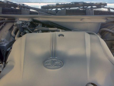 2001 Mercury Grand Marquis - The engine bay is covered in a thick layer of dust, obscuring details of the 4.6 liter engine.