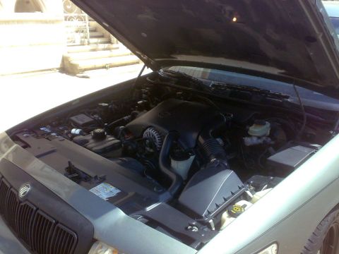 2001 Mercury Grand Marquis - The engine bay of a 2001 Mercury Grand Marquis is shown with the hood open.
