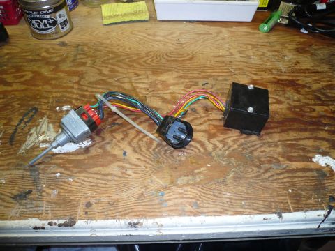 1975 Ford Ranchero - A close-up view of an automotive electrical switch and its associated wiring harness, laid out on a workbench.
