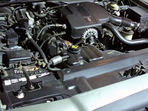 2001 Mercury Grand Marquis - Close-up view of a vehicle's engine bay, showing the V8 engine cover and battery.