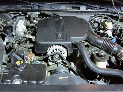 2001 Mercury Grand Marquis - Close-up view of a car's engine bay, focusing on the air intake and alternator assembly.