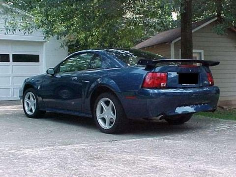 1999 Ford Mustang - This blue Ford Mustang features a rear spoiler and distinctive taillights.