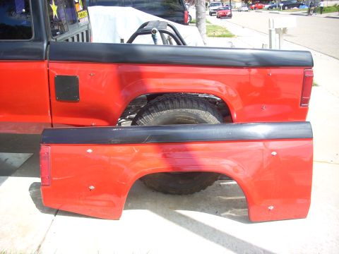 1992 Ford Ranger - Two red truck bed panels are shown, one attached to a vehicle and the other detached.