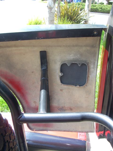 1992 Ford Ranger - Close-up of a vehicle's interior door panel, showing a roll cage and a carbon fiber insert.