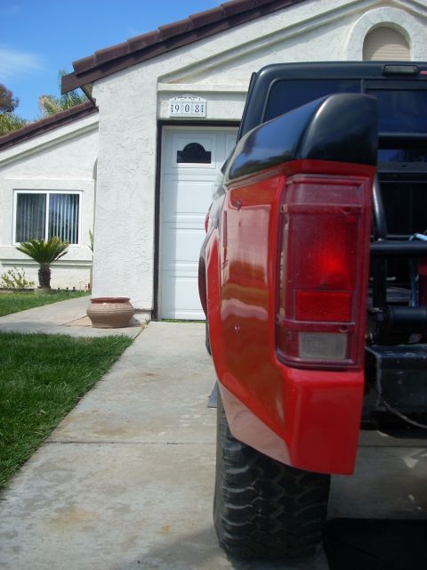1992 Ford Ranger - A red pickup truck is parked in front of a garage with a license plate that reads 9081.