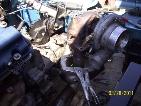 1995 Ford Probe - Turbocharger installation in progress, showing the assembly clamped with vise grips.