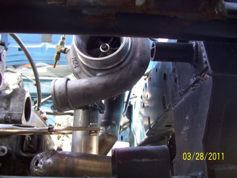 1995 Ford Probe - Custom turbocharger setup being installed, with visible piping and engine components.