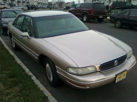 2004 Acura TL - This Buick LeSabre is parked on a residential street next to a sidewalk and grass.