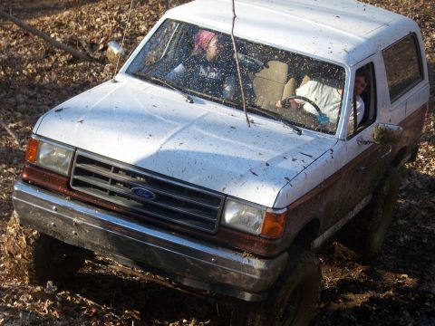1989 Ford Bronco - This Ford Bronco appears to be from the late 1980s, possibly a 1987 model, navigating a muddy trail.