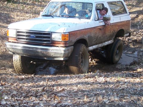 1989 Ford Bronco - This Ford Bronco appears to be from the late 1980s, not 1989, as it navigates a muddy trail.