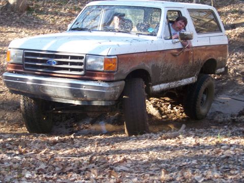 1989 Ford Bronco - This 1989 Ford Bronco navigates a muddy trail, its off-road capabilities.